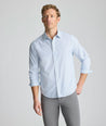 Model is wearing UNTUCKit Performance Fairfax Shirt in blue. 