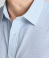 Model is wearing UNTUCKit Performance Fairfax Shirt in blue. 