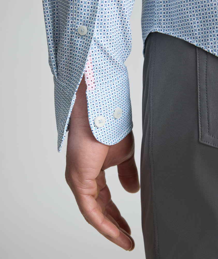 Model is wearing UNTUCKit Performance Fairfax Shirt in blue. 