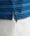 Model is wearing UNTUCKit Performance Hybrid Polo in dark blue. 