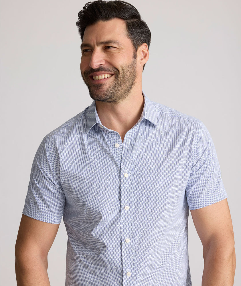Model is wearing UNTUCKit Fuller performance shirt in dot print. 