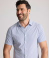 Model is wearing UNTUCKit Fuller performance shirt in dot print. 