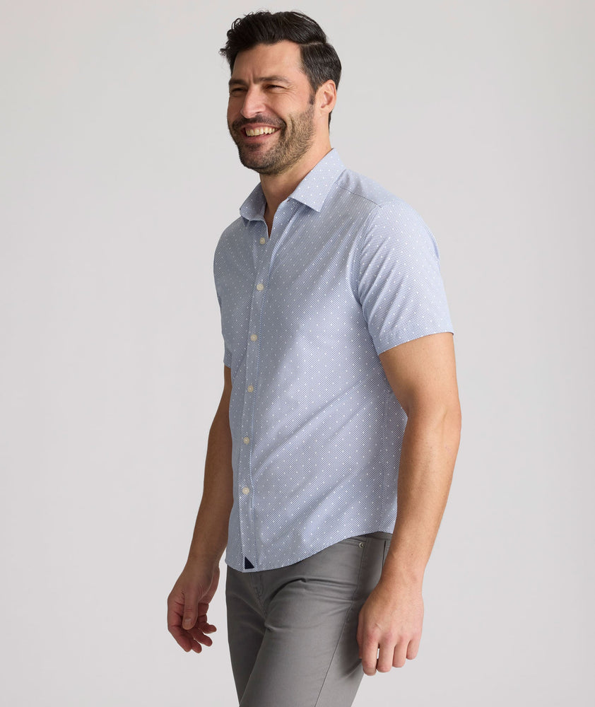 Model is wearing UNTUCKit Fuller performance shirt in dot print. 
