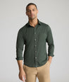 Model is wearing UNTUCKit Gironde performance shirt in Kombu green. 