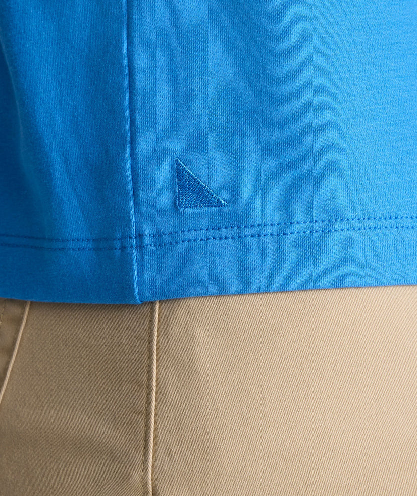 Model is wearing UNTUCKit EcoSoft Short-Sleeve Henley in light blue. 