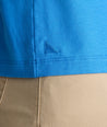 Model is wearing UNTUCKit EcoSoft Short-Sleeve Henley in light blue. 