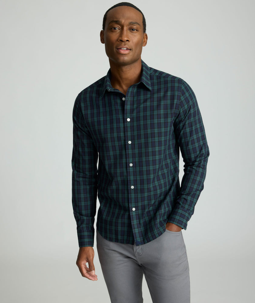 Model is wearing UNTUCKit Wrinkle-Free Grant Shirt in  Green & Navy Tartan.