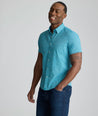 Model is wearing UNTUKit Halloway performance shirt in teal. 