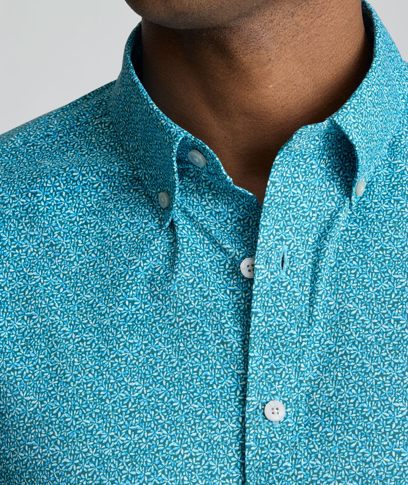 Model is wearing UNTUKit Halloway performance shirt in teal. 