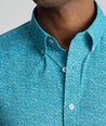 Model is wearing UNTUKit Halloway performance shirt in teal. 