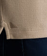 Model is wearing UNTUCKit Harrow henley in cobblestone. 