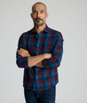 Model is wearing UNTUCKit Heinrich flannel in plaid blue. 