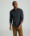 Model is wearing UNTUCKit Flannel Hemsworth Shirt in Deep Gray Herringbone.