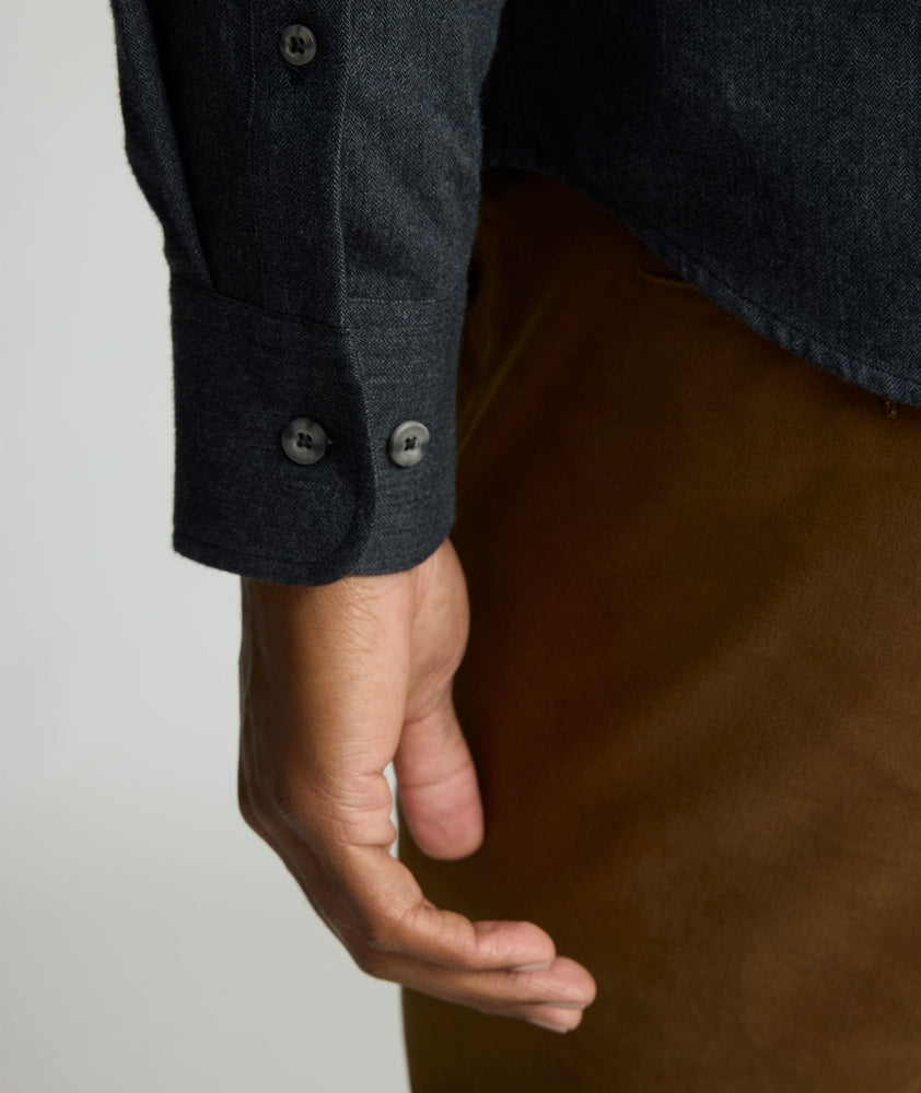Model is wearing UNTUCKit Flannel Hemsworth Shirt in Deep Gray Herringbone.