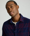 Model is wearing UNTUCKit Cord Shirt in blue and purple plaid. 