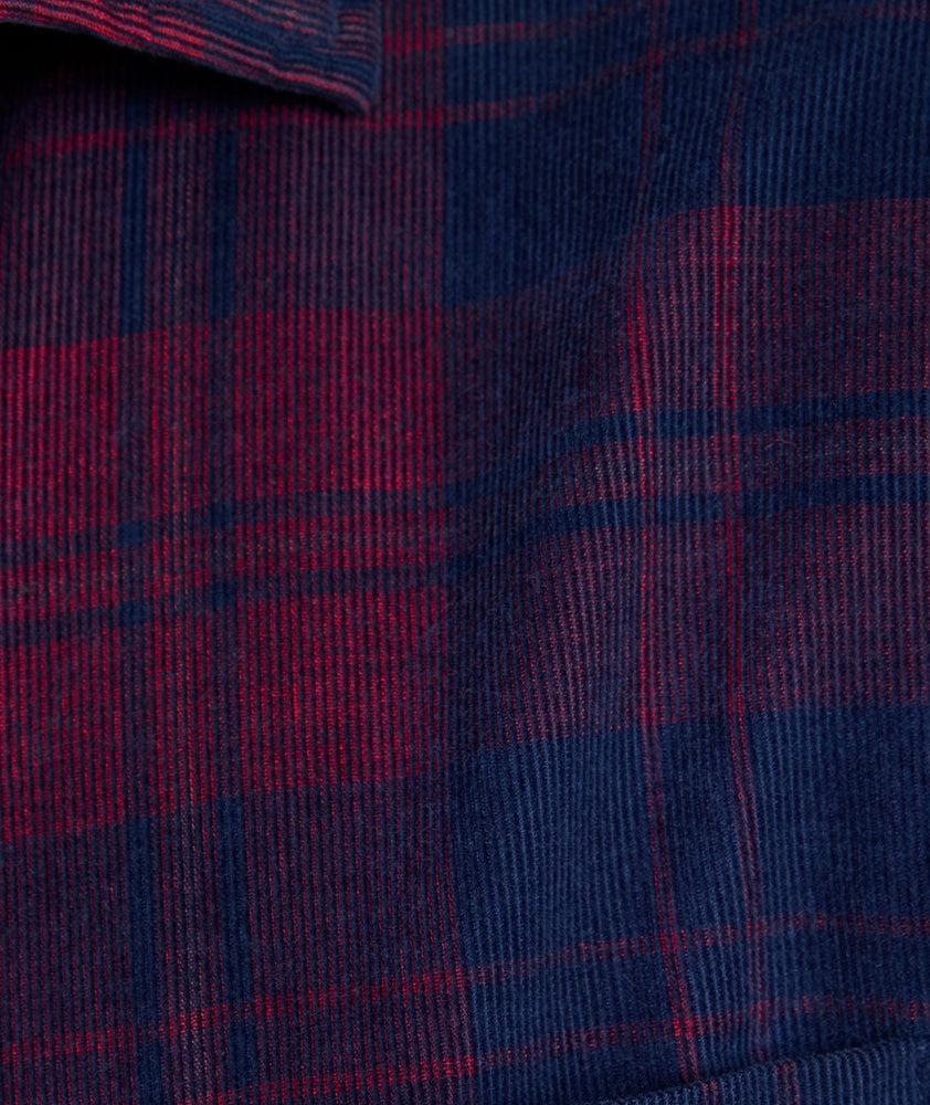 Model is wearing UNTUCKit Cord Shirt in blue and purple plaid. 