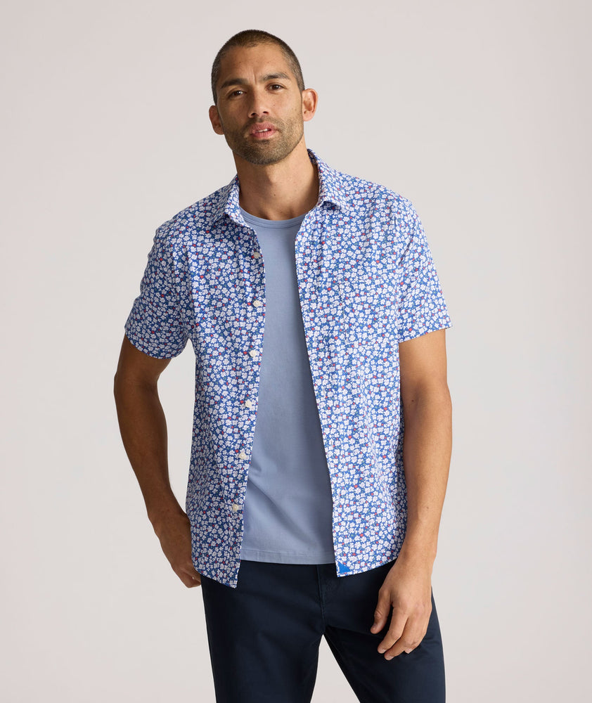 Model is wearing UNTUCKit Kincaid shirt in blue floral print. 
