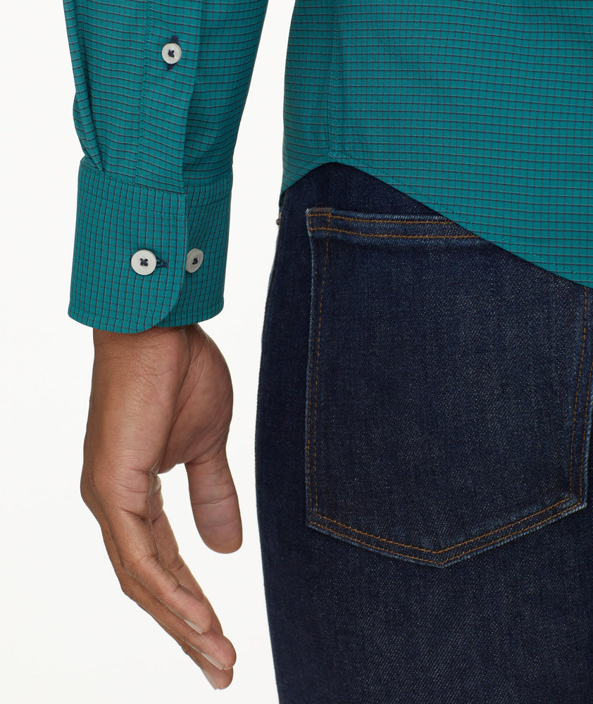 Model is wearing UNTUCKit Wrinkle-Free Performance Langhorne Shirt in Green Grounded Check.