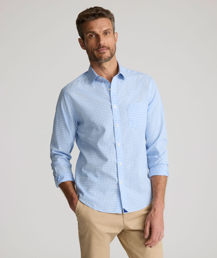 Model is wearing UNTUCKit Lawrence wrinkle free in light blue gingham. 
