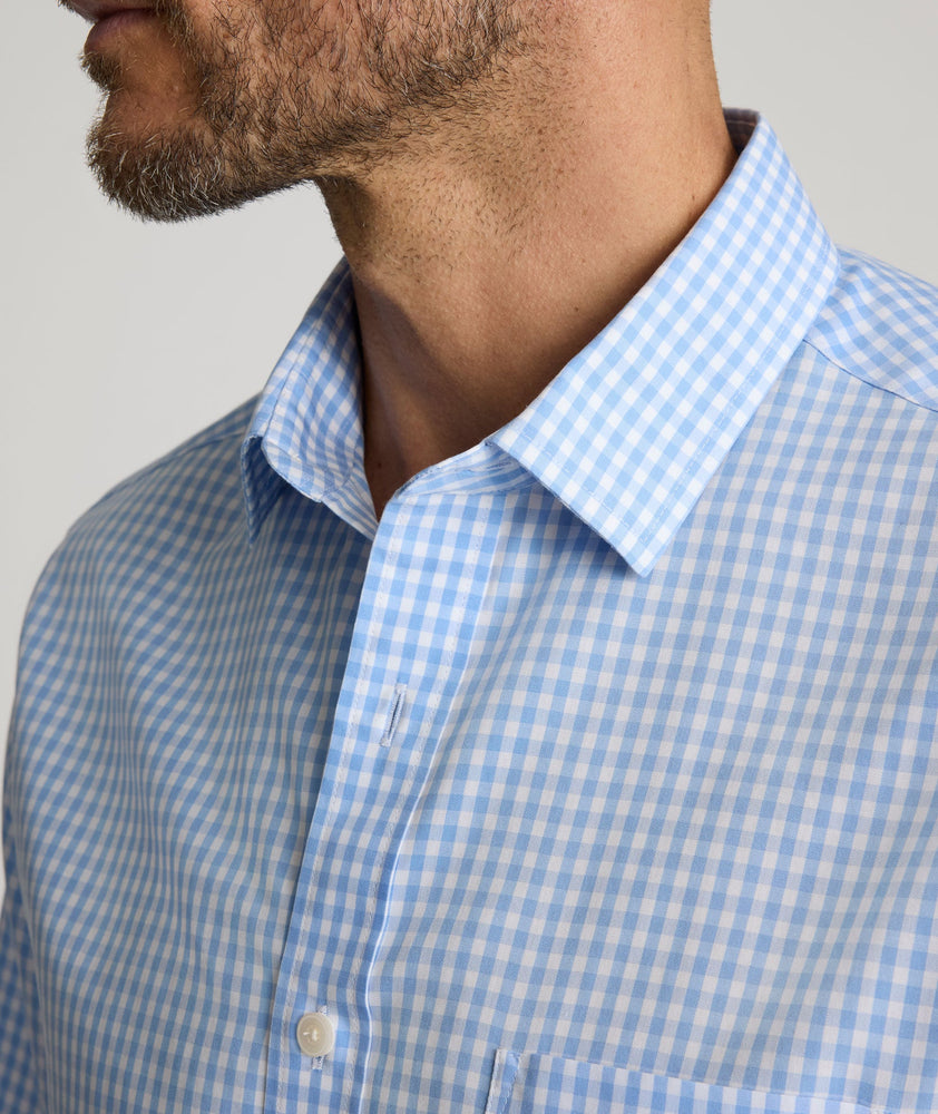 Model is wearing UNTUCKit Lawrence wrinkle free in light blue gingham. 