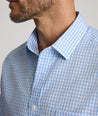 Model is wearing UNTUCKit Lawrence wrinkle free in light blue gingham. 