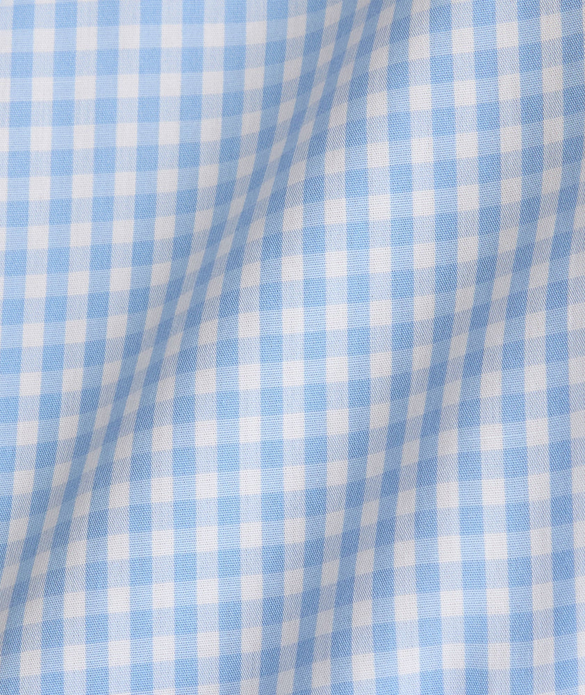 Model is wearing UNTUCKit Lawrence wrinkle free in light blue gingham. 