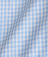 Model is wearing UNTUCKit Lawrence wrinkle free in light blue gingham. 