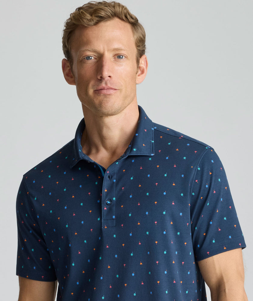 Model is wearing UNTUCKit Wrinkle-Free Damaschino Polo in navy floral. 