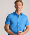 Model is wearing UNTUCKit Performance Short-Sleeve Livingston Shirt in Blue Shark Fin Print.