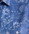 Model is wearing UNTUCKit Monroe cotton linen short sleeve shirt in blue print. 