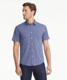 Model is wearing UNTUCKit Wrinkle-Free Performance Short-Sleeve Murphy Shirt in Blue With Small Geo Print.