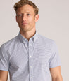 Model is wearing UNTUCKit Performance Short-Sleeve Nouveau Shirt in Navy Geo Print.