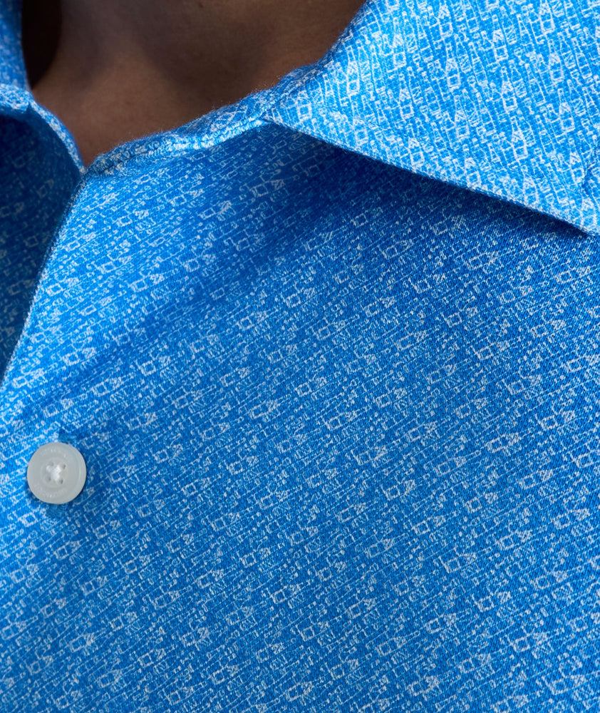 Model is wearing UNTUCKit CottonTek Polo in blue. 