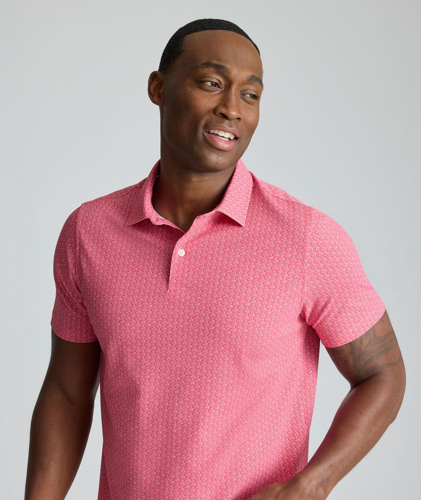 Model is wearing UNTUCKit Model is wearing UNTUCKit CottonTek Polo in Magenta Wine Bottle Print.