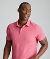 Model is wearing UNTUCKit Model is wearing UNTUCKit CottonTek Polo in Magenta Wine Bottle Print.
