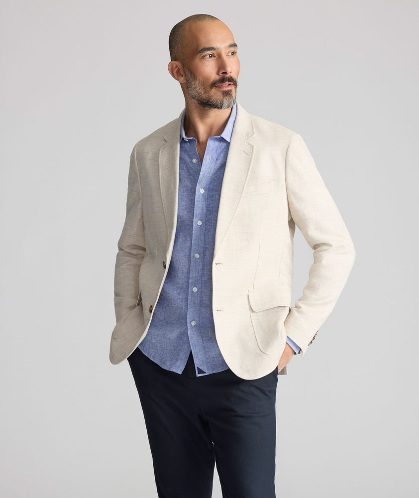 Model is wearing UNTUCKit Linen-Cotton Sagefield Sport Coat in Tan.