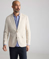 Model is wearing UNTUCKit Linen-Cotton Sagefield Sport Coat in Tan.
