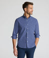 Model is wearing UNTUCKit Wrinkle-Free Solay Shirt in Navy Check. 