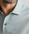 Model is wearing UNTUCKit Textured Performance Polo in green. 