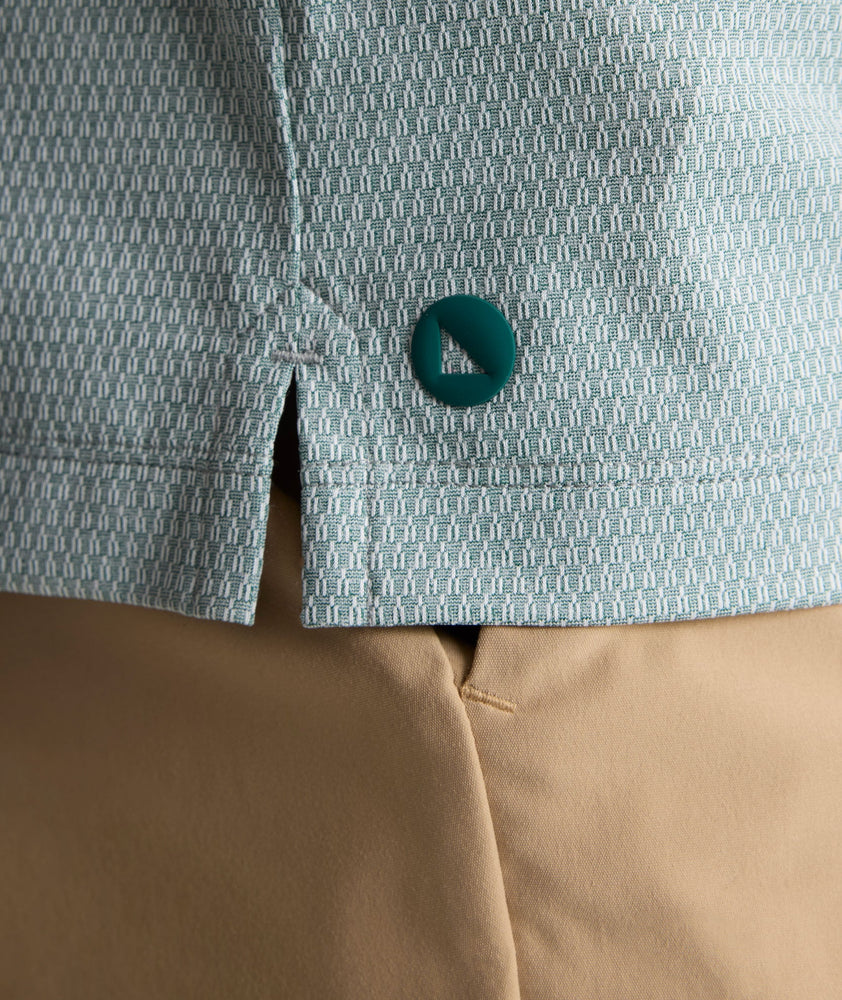 Model is wearing UNTUCKit Textured Performance Polo in green. 