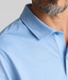 Model is wearing UNTUCKit Textured Performance Polo in blue. 