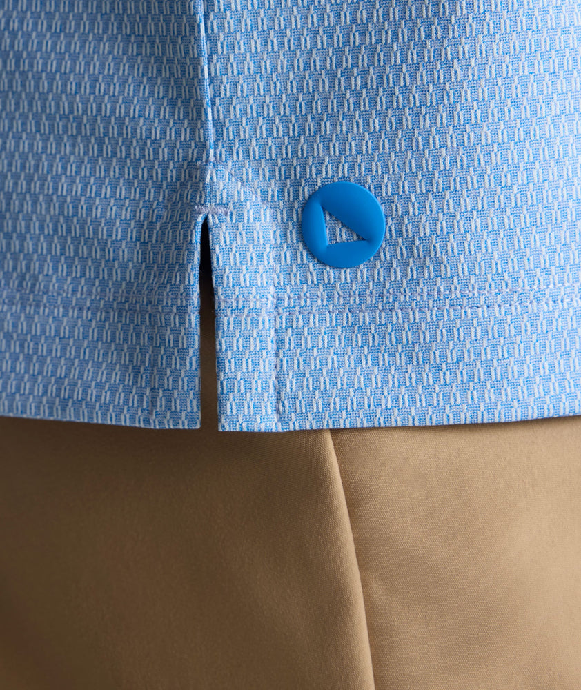 Model is wearing UNTUCKit Textured Performance Polo in blue. 