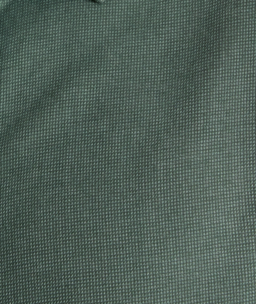 Model is wearing UNTUCKIt Wrinkle-Free Veneto Shirt in Deep Forest.