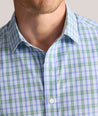 Model is wearing UNTUCKit Performance Whitman Shirt in Blue & Green Plaid