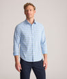 Model is wearing UNTUCKit Performance Whitman Shirt in Blue & Green Plaid