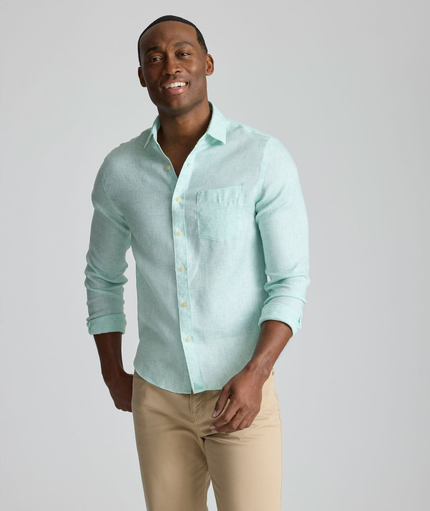 Model is wearing UNTUCKit Wrinkle-Resistant Linen Wildehart Shirt in green. 