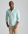 Model is wearing UNTUCKit Wrinkle-Resistant Linen Wildehart Shirt in green. 