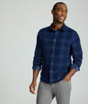 Model is wearing Cord Shirt in Navy Plaid.