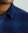 Model is wearing Cord Shirt in Navy Plaid.