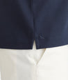 Model is wearing UNTUCKit Navy Tipped Johnny Collar Polo.